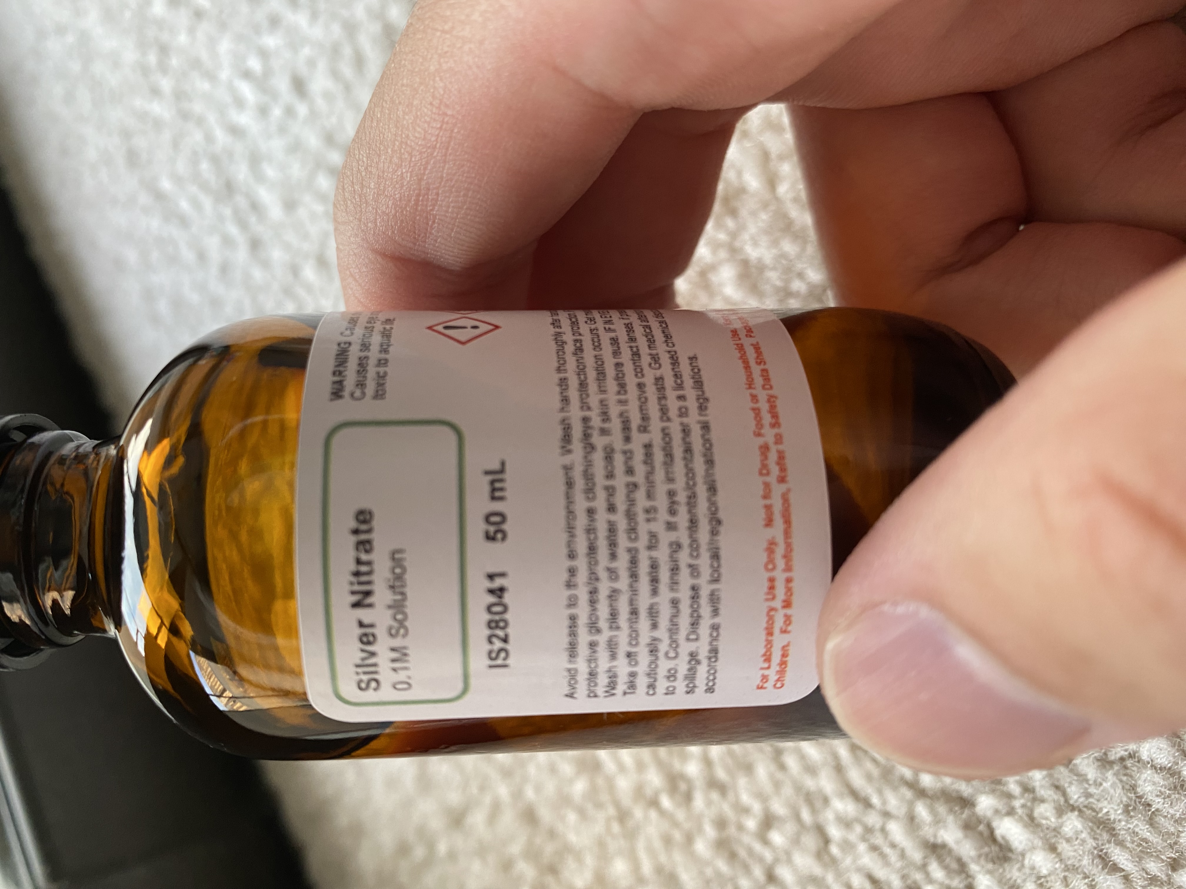 0.1 M AgNO3 solution in an amber bottle