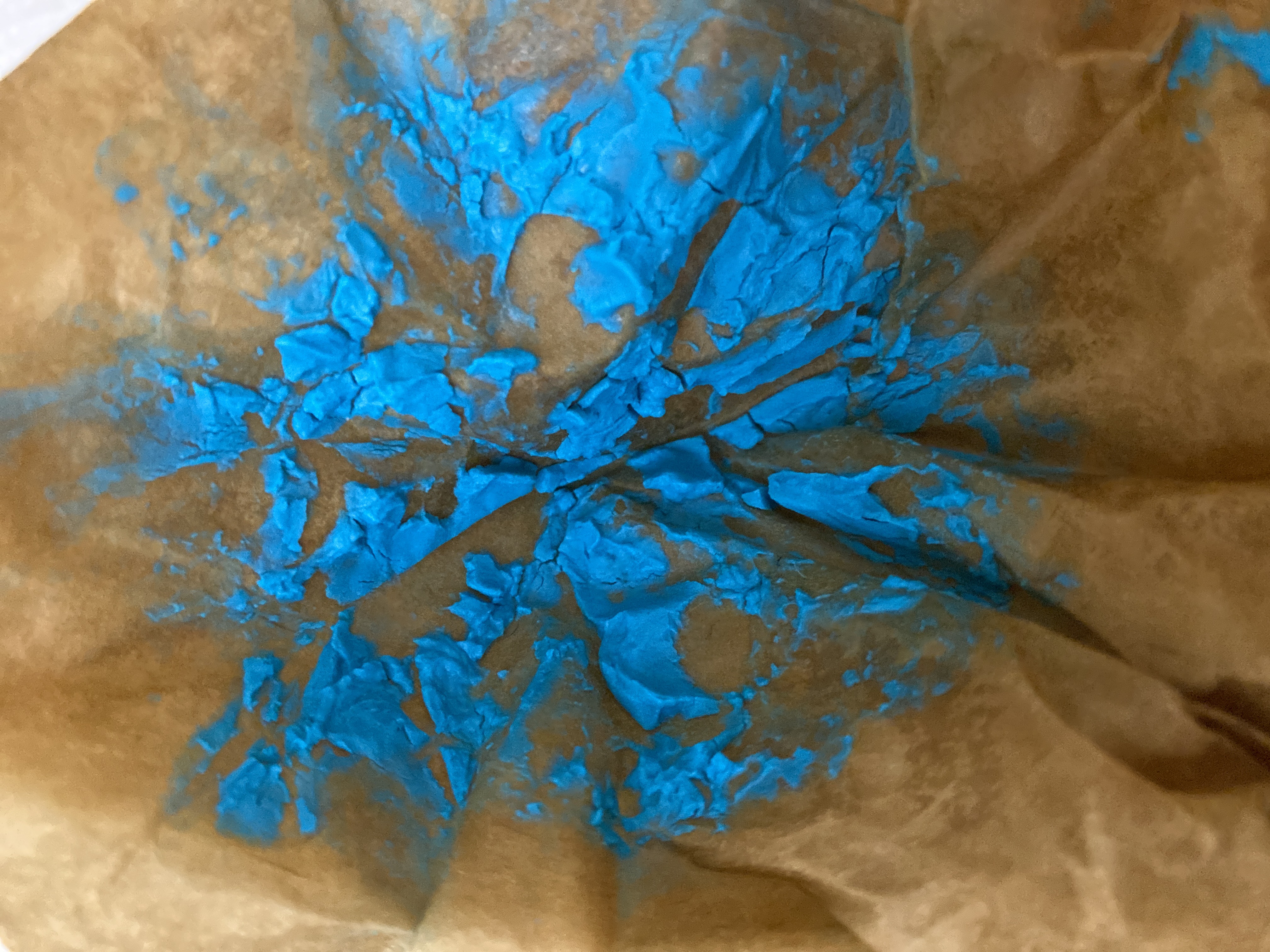 Wet filter paper showing freshly filtered malachite precipitate